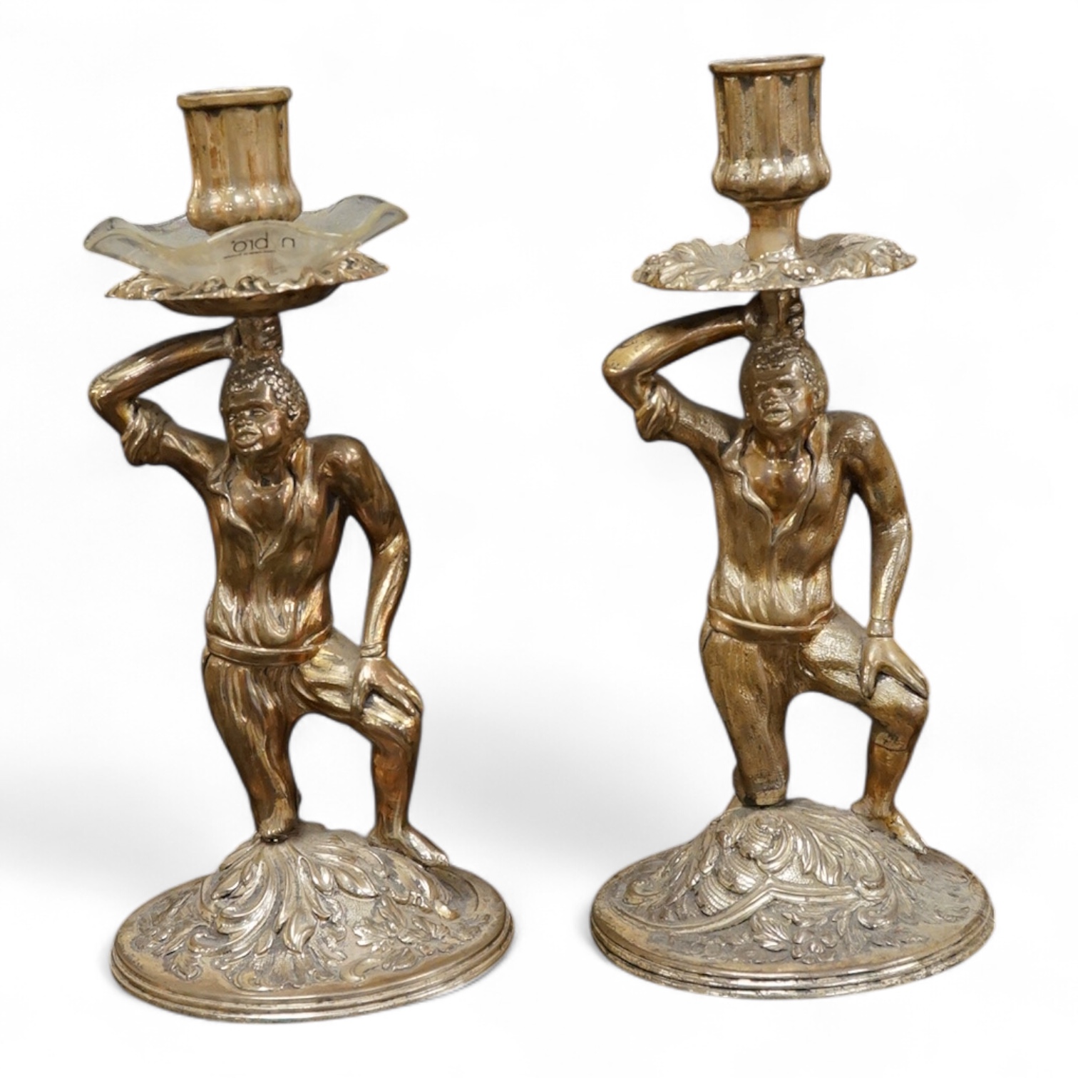 A pair of Blackamoor silvered brass candlesticks, 19cm high